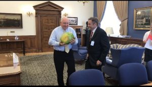 Arney and Perdue look at a watermelon
